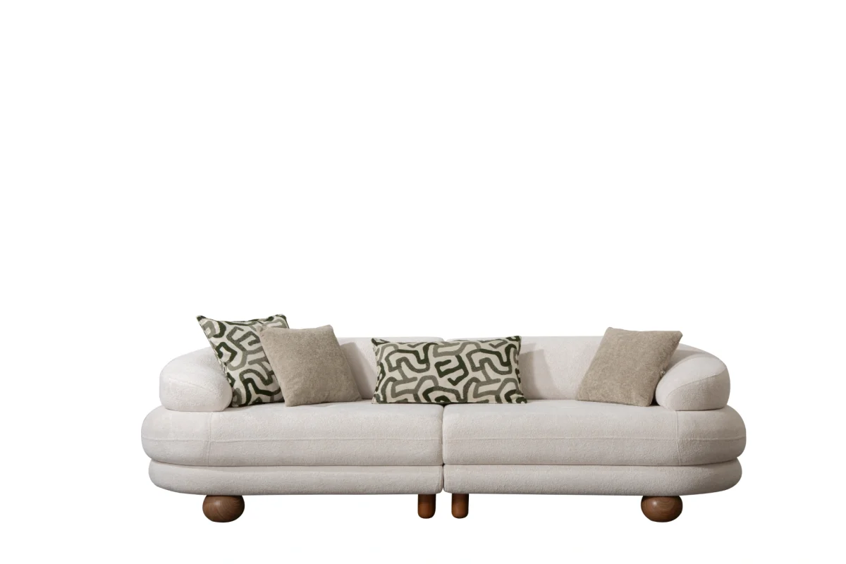 Premium sand grey curved sofa with sculptural round wooden legs and decorative cushions