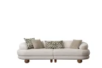 Premium sand grey curved sofa with sculptural round wooden legs and decorative cushions