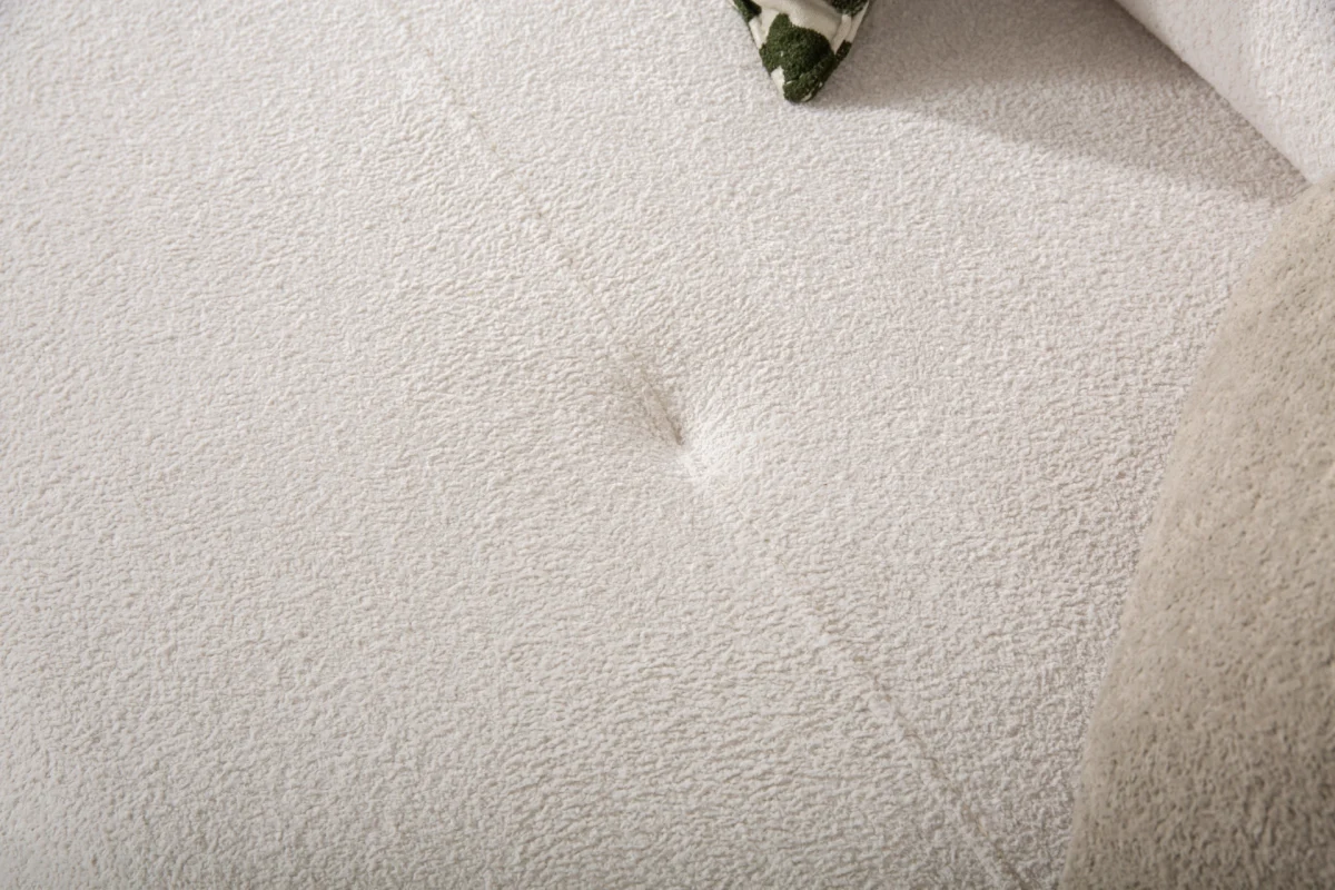 Premium sand grey curved sofa with sculptural round wooden legs and decorative cushions