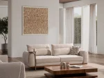 A modern textured fabric sofa featuring rounded armrests, adjustable horizontal back cushions, a dark wood plinth base, and a sleek integrated metallic side tray table in a minimalist living room setting.