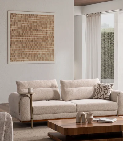 A modern textured fabric sofa featuring rounded armrests, adjustable horizontal back cushions, a dark wood plinth base, and a sleek integrated metallic side tray table in a minimalist living room setting.