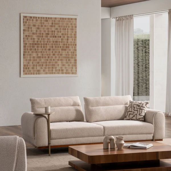 A modern textured fabric sofa featuring rounded armrests, adjustable horizontal back cushions, a dark wood plinth base, and a sleek integrated metallic side tray table in a minimalist living room setting.