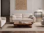 A modern textured fabric sofa featuring rounded armrests, adjustable horizontal back cushions, a dark wood plinth base, and a sleek integrated metallic side tray table in a minimalist living room setting.