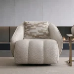 The elite Levni Armchair arranged in a high-end, modern living room with sophisticated wall paneling and artistic lighting, embodying a prestigious and balanced lifestyle.