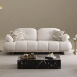 The elite Levni Sofa arranged in a high-end, modern living room with sophisticated wall paneling and artistic lighting, embodying a prestigious and balanced lifestyle.