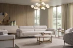 Lina Three Seater Sofa featuring distinct armrest accents, metallic leg details, and a spacious seat cushion layout.