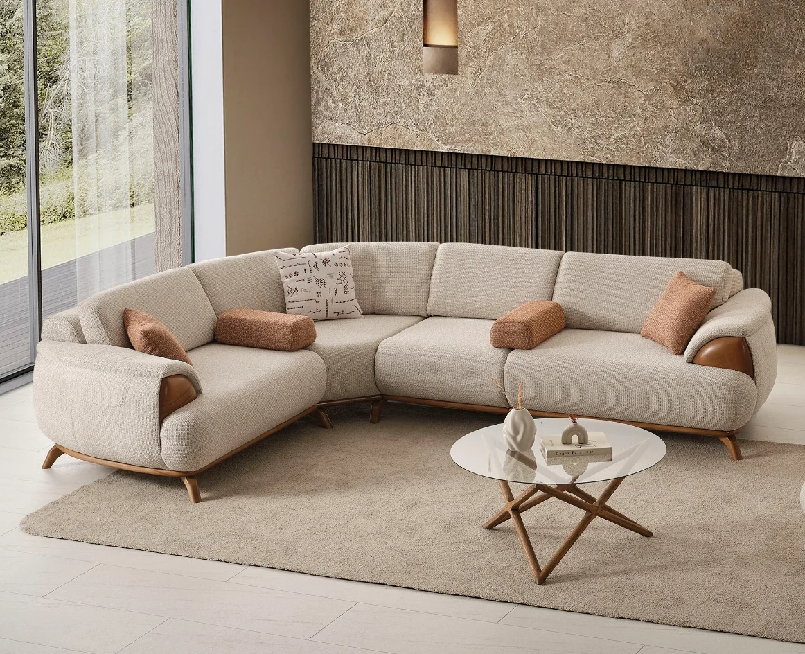 Loria Corner Sofa 4 Modules Modern modular corner sofa from Turkey 3 Loria Corner Sofa – 4 Modules four-piece sectional sofa in light beige upholstery featuring wooden armrest details, terracotta bolster cushions, and natural wooden legs.