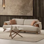 Loria Sofa combines organic curved contours, refined wooden armrest accents, and plush seating comfort to elevate modern living interiors. Experience premium quality with SofaTurkey™️.