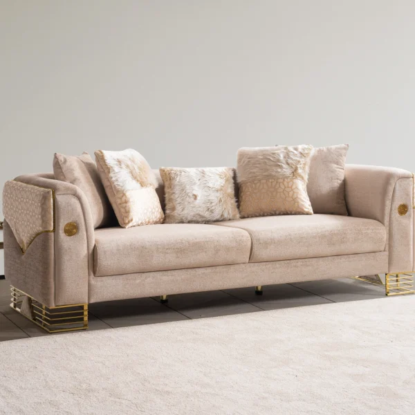 Luxia Sofa Set featuring a charcoal velvet three-seater, a blush pink loveseat with geometric patterns, and matching armchairs. The set is detailed with gold-toned metal bases and frames, set in a neoclassical room with arched windows and ornate wall moldings.