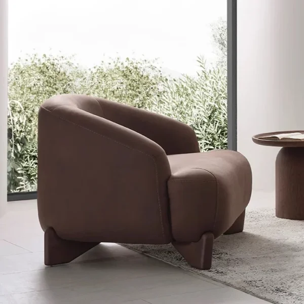 The distinguished Mirae Armchair in a bright, modern interior with curved architectural details and warm wooden accents, embodying a sense of balance and harmony.