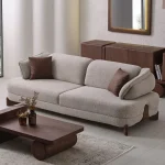 The distinguished Mirae Sofa in a bright, modern interior with curved architectural details and warm wooden accents, embodying a sense of balance and harmony.