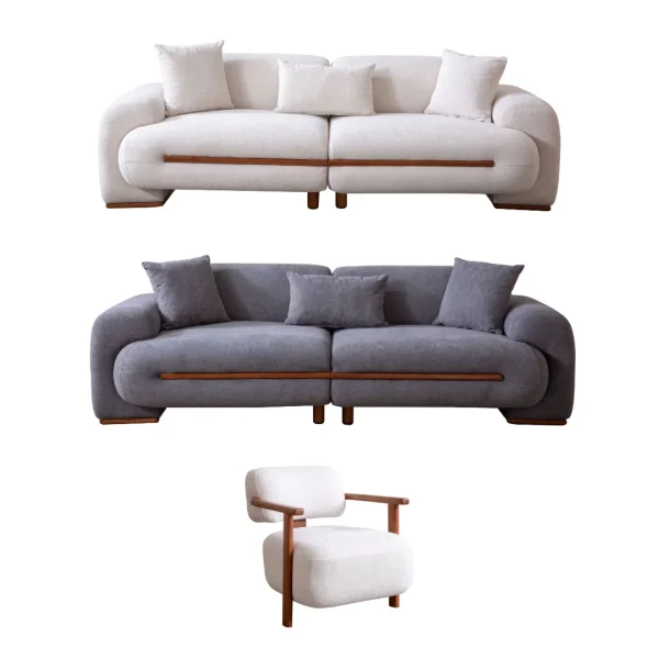 Nile Sofa Set featuring a large cream-colored bouclé sofa, a matching grey loveseat, and a stylish accent chair with wooden arms. The furniture is arranged in a high-end modern interior with textured stone walls and artistic lighting.