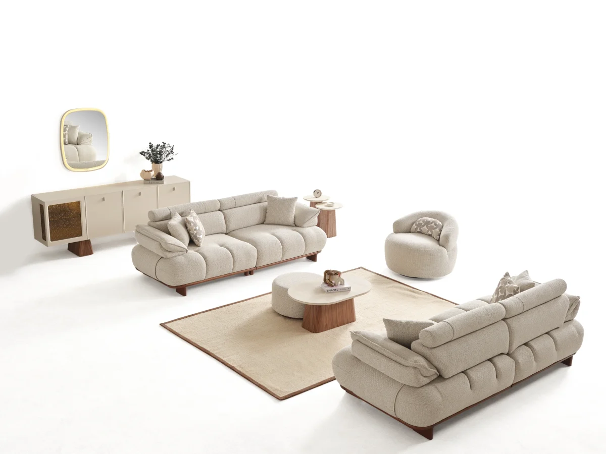 Experience comfort with the Nola Sofa Set. Its elegant fabric and curved silhouette offer a perfect blend of modern aesthetics and comfortable living.