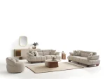 Experience comfort with the Nola Sofa Set. Its elegant fabric and curved silhouette offer a perfect blend of modern aesthetics and comfortable living.
