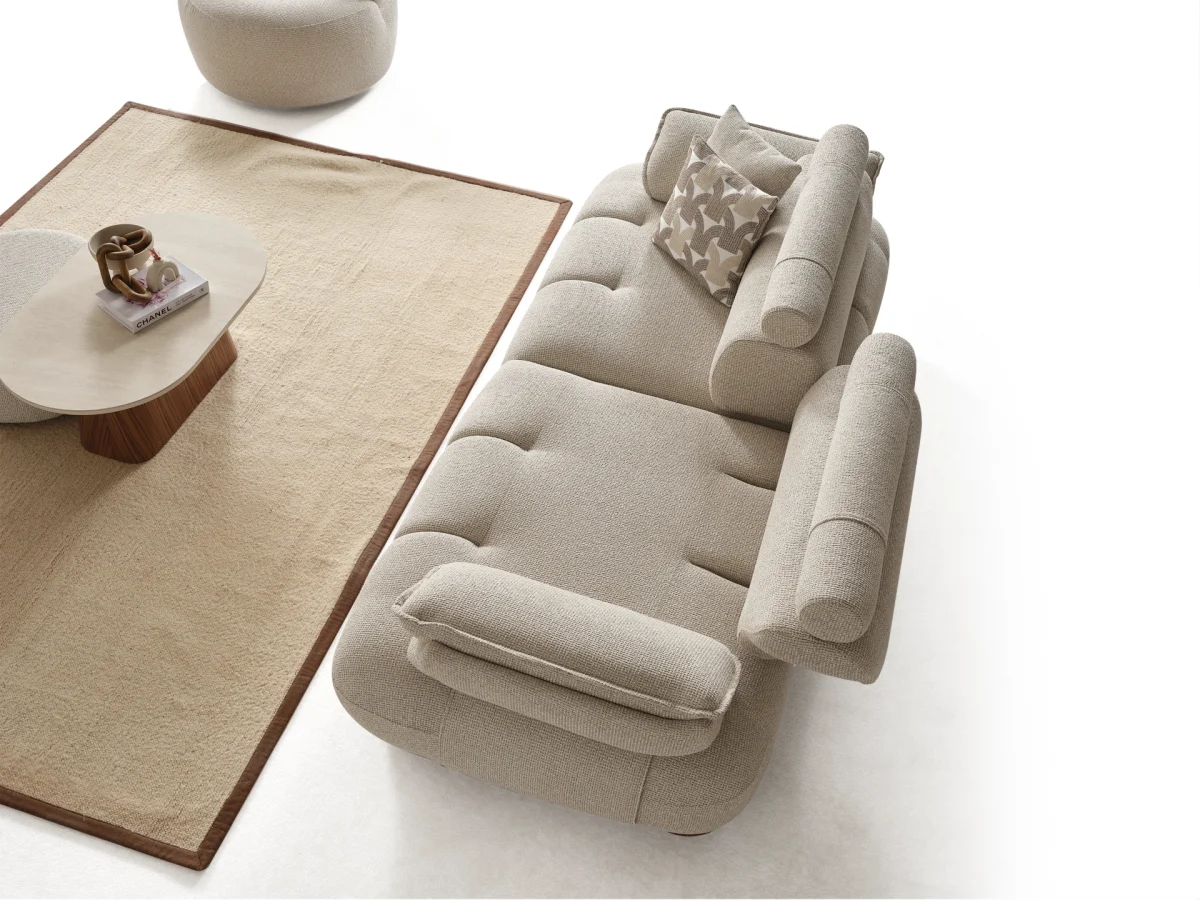 The Nola Sofa adds an architectural touch to your living room with its flowing lines and tactile richness. Experience comfort wrapped in the season's trendiest fabric.