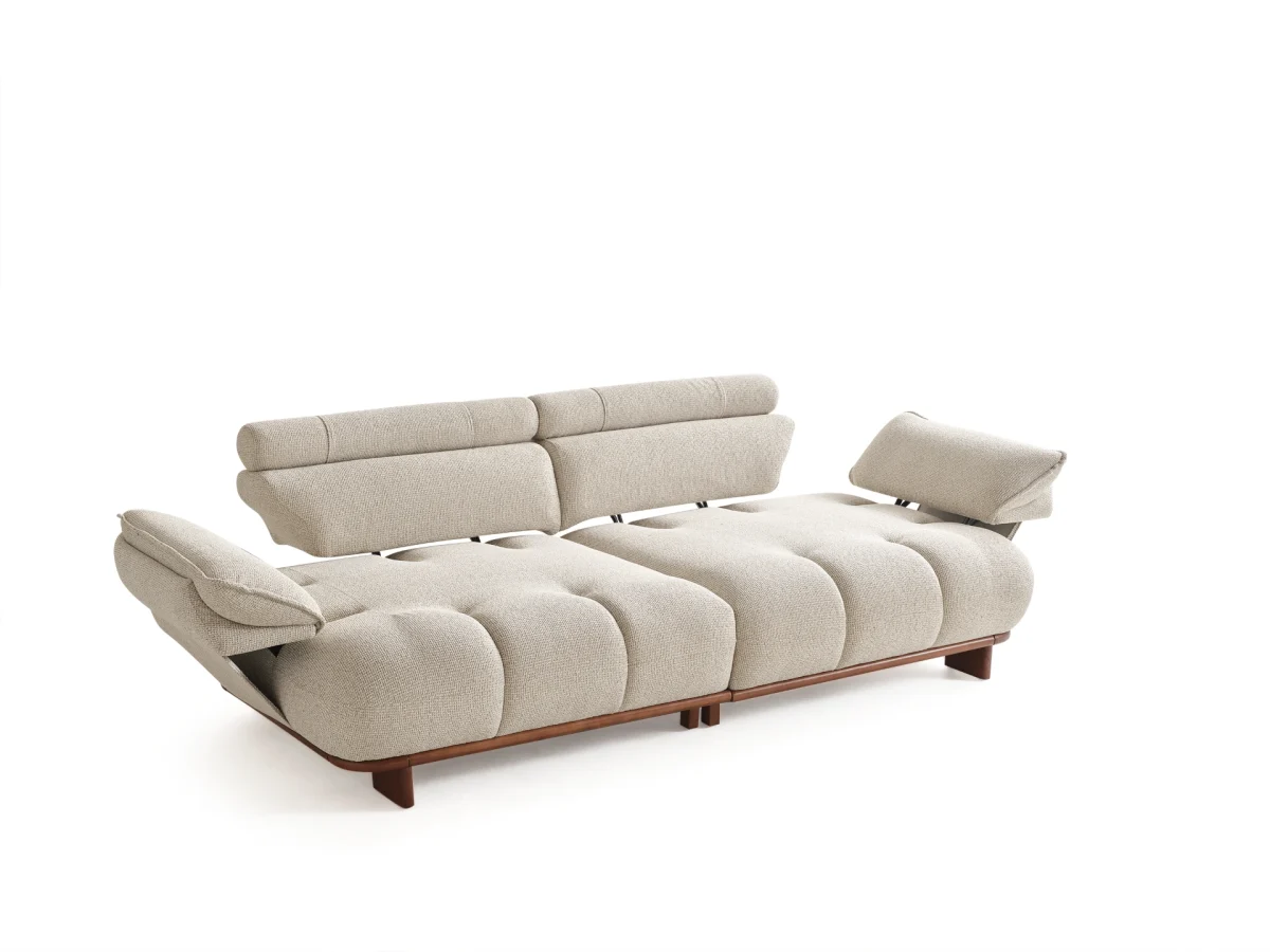 The Nola Sofa adds an architectural touch to your living room with its flowing lines and tactile richness. Experience comfort wrapped in the season's trendiest fabric.