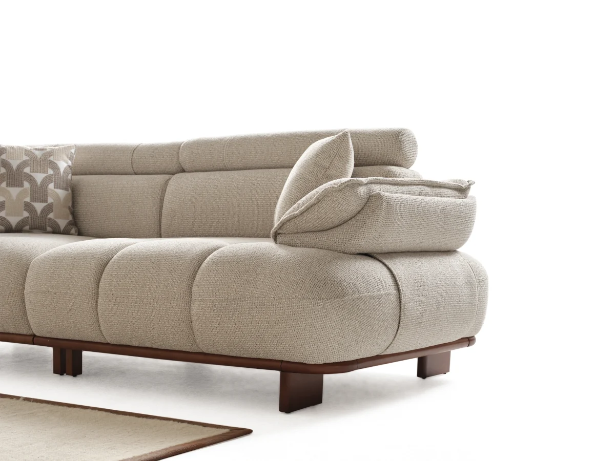The Nola Sofa adds an architectural touch to your living room with its flowing lines and tactile richness. Experience comfort wrapped in the season's trendiest fabric.