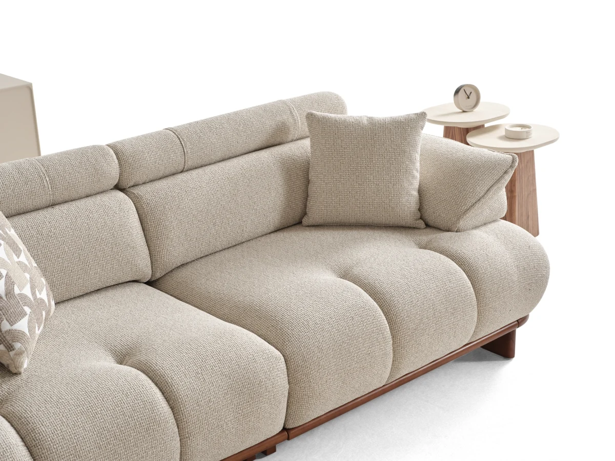The Nola Sofa adds an architectural touch to your living room with its flowing lines and tactile richness. Experience comfort wrapped in the season's trendiest fabric.
