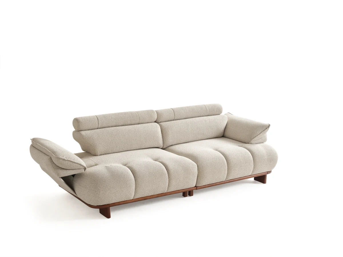 The Nola Sofa adds an architectural touch to your living room with its flowing lines and tactile richness. Experience comfort wrapped in the season's trendiest fabric.