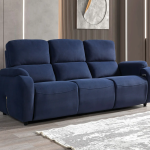 A modern three-seater reclining sofa featuring generous pillow-top backrests, wide padded armrests, and smooth plush upholstery set against a contemporary interior wall.