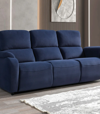 A modern three-seater reclining sofa featuring generous pillow-top backrests, wide padded armrests, and smooth plush upholstery set against a contemporary interior wall.