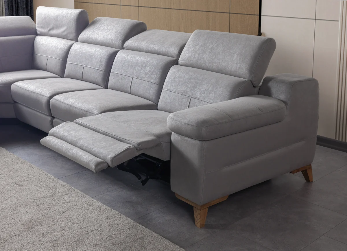 A modern L-shaped sectional sofa featuring integrated recliner functions, adjustable multi-position headrests, plush cushioned armrests, and subtle wooden support legs in a contemporary interior setting.