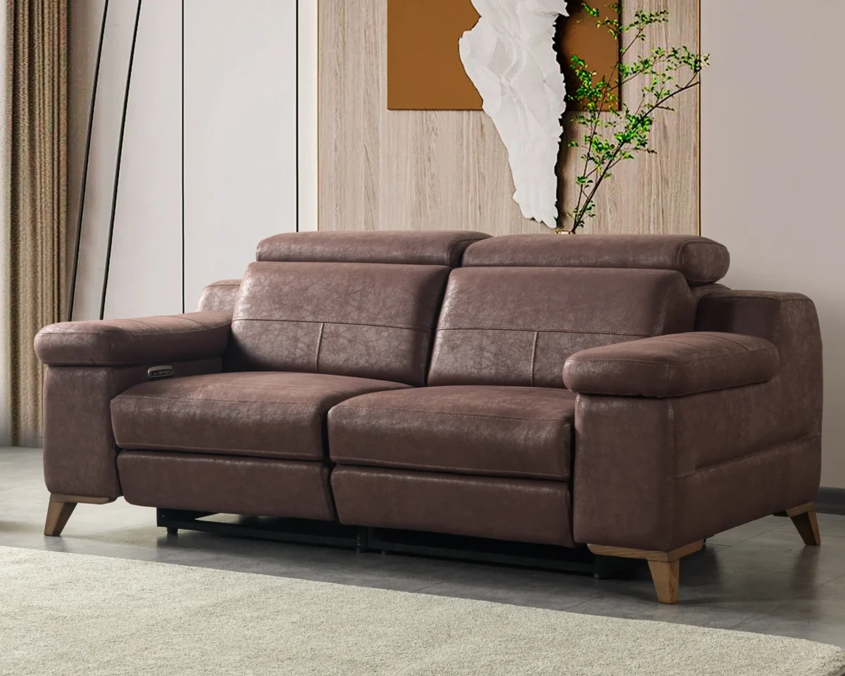 A modern multi-seater recliner sofa featuring adjustable headrests, extendable footrests, wide plush armrests, and a rich textured leatherette finish in a contemporary living room setting.