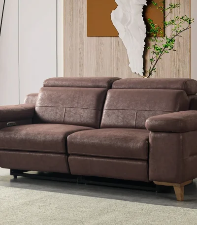A modern multi-seater recliner sofa featuring adjustable headrests, extendable footrests, wide plush armrests, and a rich textured leatherette finish in a contemporary living room setting.