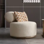 The Rumi Armchair in a sophisticated, contemporary interior with dark paneled walls and warm lighting, creating an atmosphere of deep harmony and artistic tranquility.