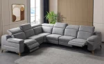 A modern L-shaped sectional sofa featuring integrated recliner functions, adjustable multi-position headrests, plush cushioned armrests, and subtle wooden support legs in a contemporary interior setting.
