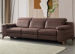A modern multi-seater recliner sofa featuring adjustable headrests, extendable footrests, wide plush armrests, and a rich textured leatherette finish in a contemporary living room setting.