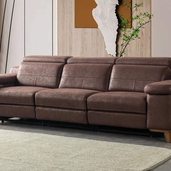 A modern multi-seater recliner sofa featuring adjustable headrests, extendable footrests, wide plush armrests, and a rich textured leatherette finish in a contemporary living room setting.