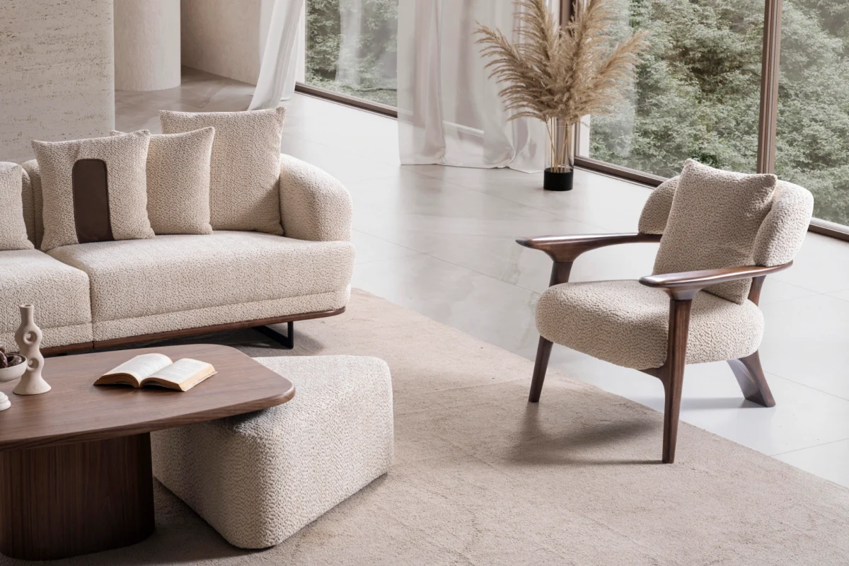 Sola Armchair with an exposed wooden frame, smooth wooden armrests, and a curved cushioned backrest