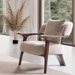 Sola Armchair with an exposed wooden frame, smooth wooden armrests, and a curved cushioned backrest