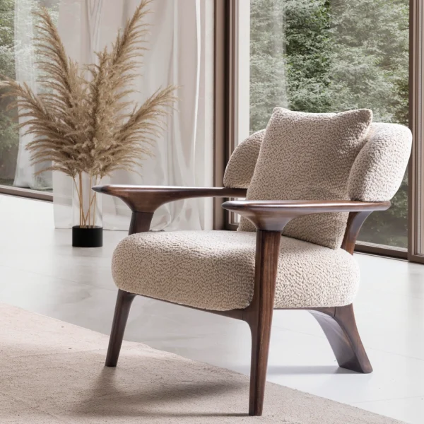 Sola Armchair with an exposed wooden frame, smooth wooden armrests, and a curved cushioned backrest