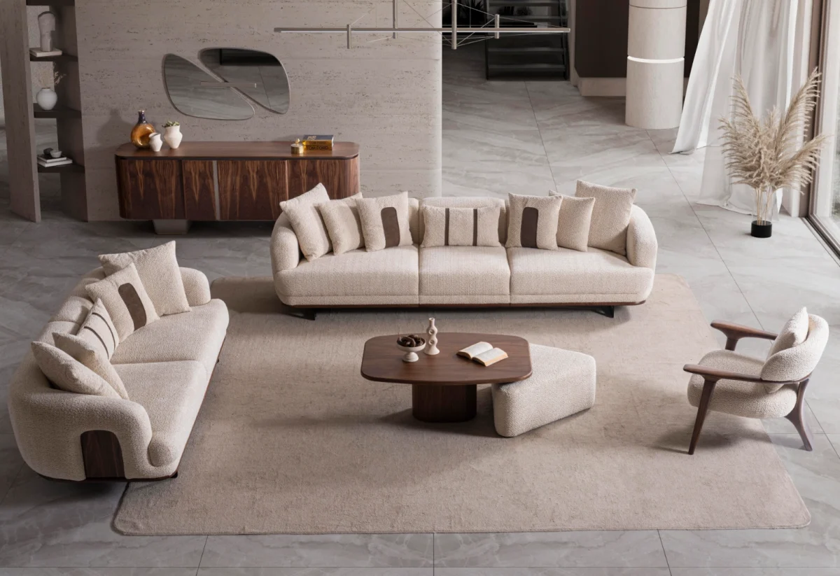 Sola Sofa Set featuring two curved modern sofas and a matching armchair arranged around a coffee table in a spacious living room.
