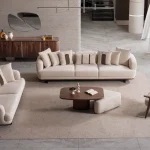 Sola Sofa Set featuring two curved modern sofas and a matching armchair arranged around a coffee table in a spacious living room.
