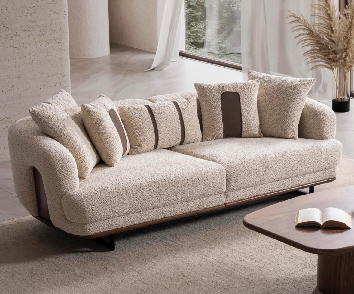 Sola sofa cozy boucl textured sofa Sofaturkey living room furniture sofa 9 Sola Sofa featuring rounded armrests, plush back cushions, and a wooden base trim in a modern living room setting.