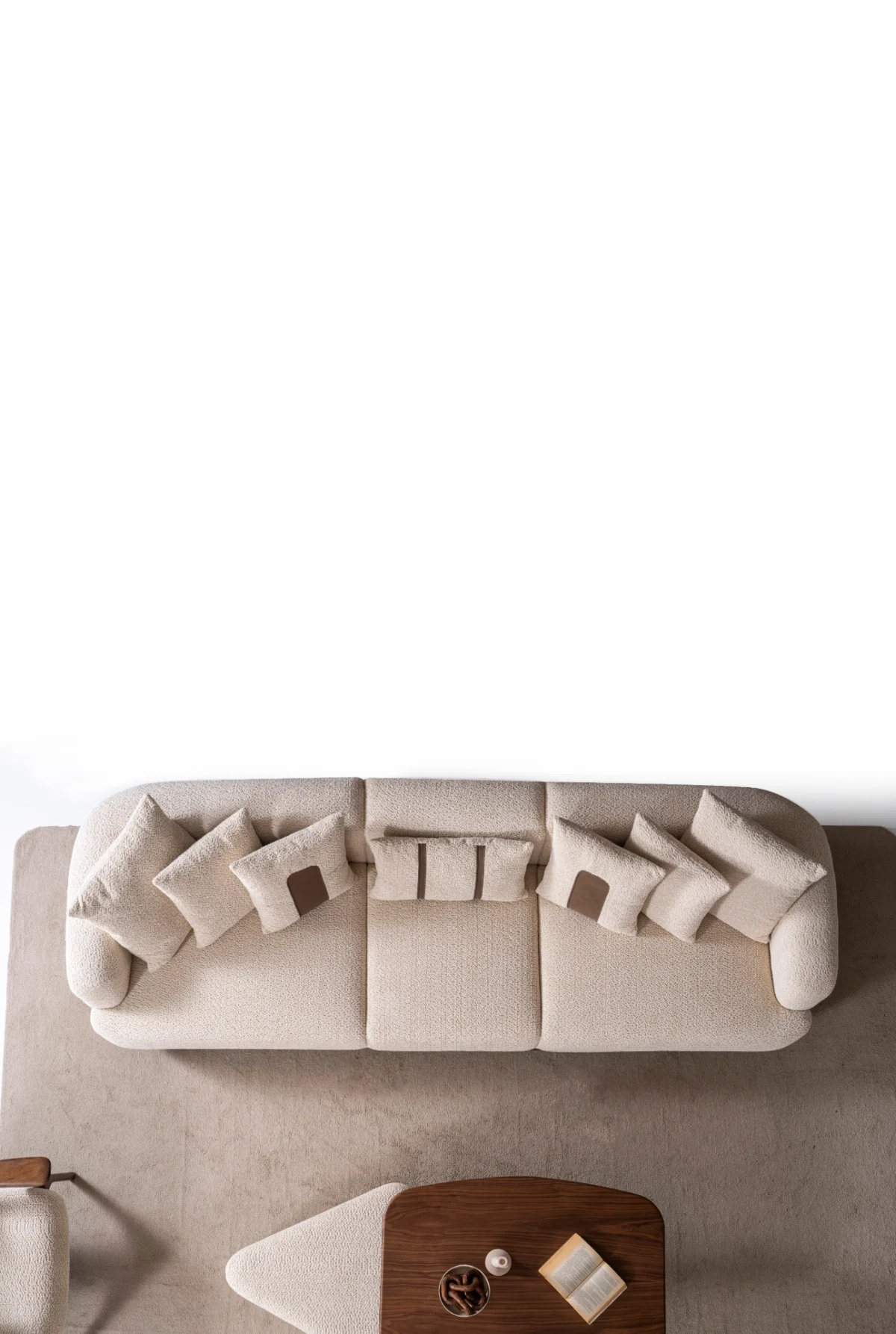 Sola Three Seater Sofa featuring rounded armrests, plush back cushions, and a wooden base trim in a modern living room setting.