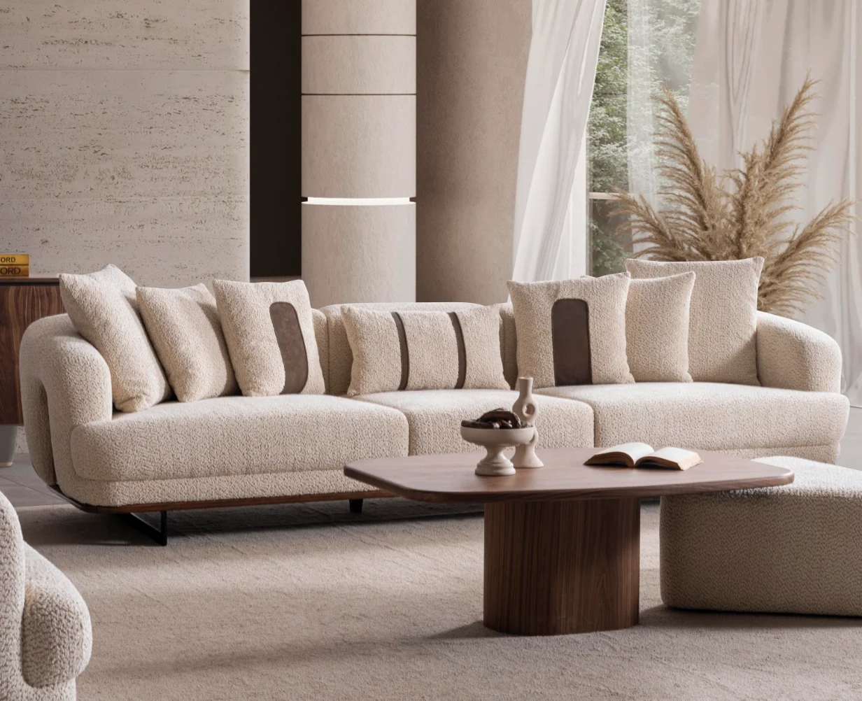 Sola three seater sofa cozy boucl textured sofa Sofaturkey living room furniture sofa 8 Sola Three Seater Sofa featuring rounded armrests, plush back cushions, and a wooden base trim in a modern living room setting.
