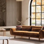 The Thalia Sofa combines organic, rounded lines with the rich texture of premium fabric. A bold piece that brings modern warmth to any living room.