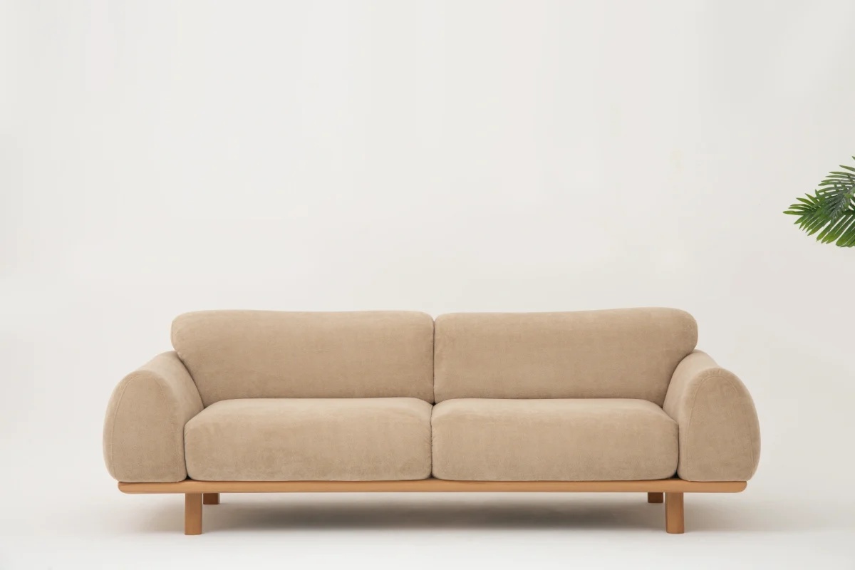 The Thalia Sofa combines organic, rounded lines with the rich texture of premium fabric. A bold piece that brings modern warmth to any living room.