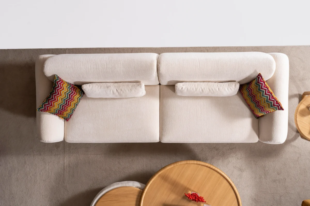 The Thalia Sofa combines organic, rounded lines with the rich texture of premium fabric. A bold piece that brings modern warmth to any living room.