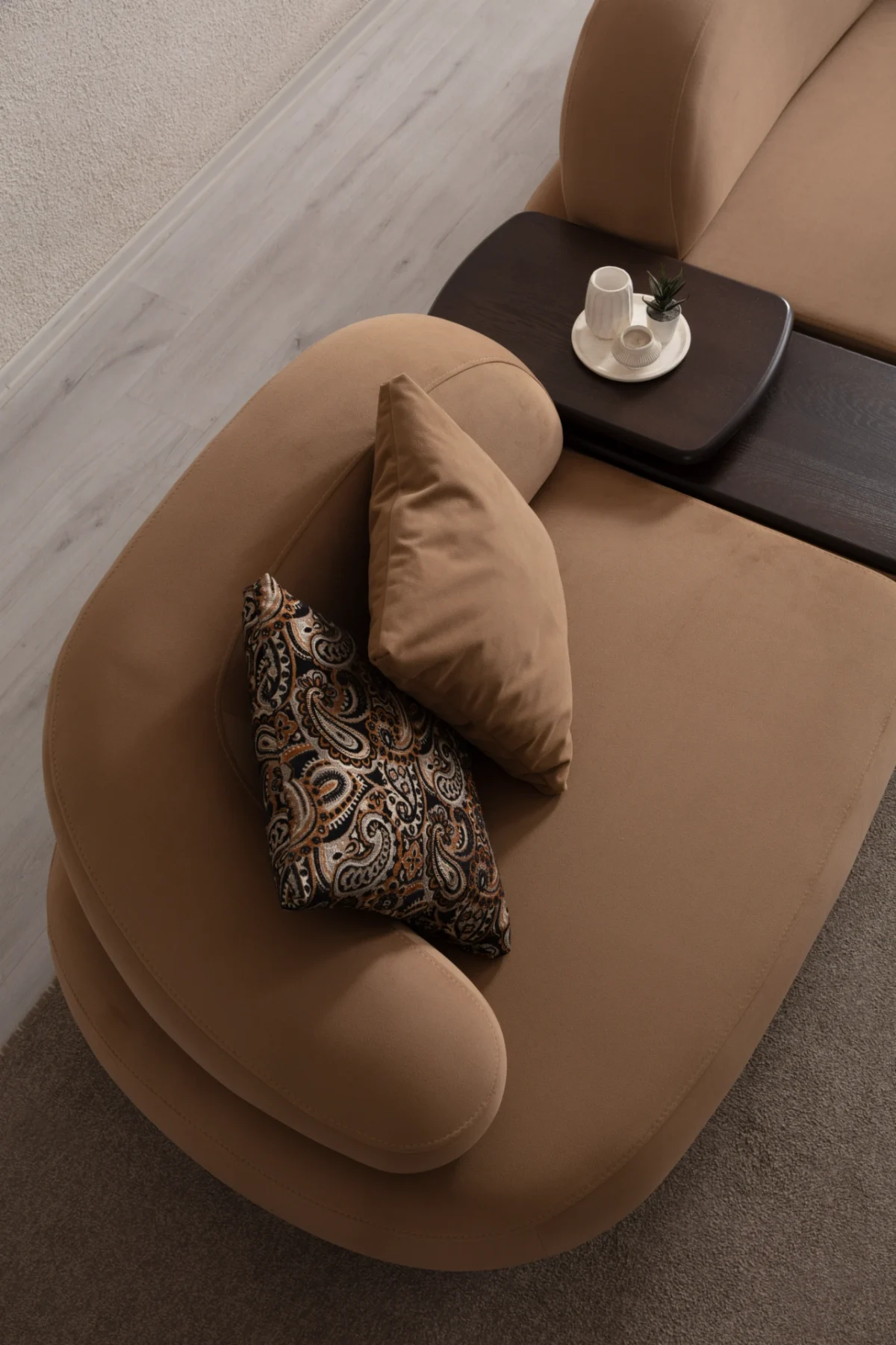 Tolia Corner Sofa - 5 Modules five-piece modular curved corner sofa featuring warm beige seating, patterned accent cushions, and an integrated wooden console table.