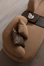 Tolia Corner Sofa - 5 Modules five-piece modular curved corner sofa featuring warm beige seating, patterned accent cushions, and an integrated wooden console table.