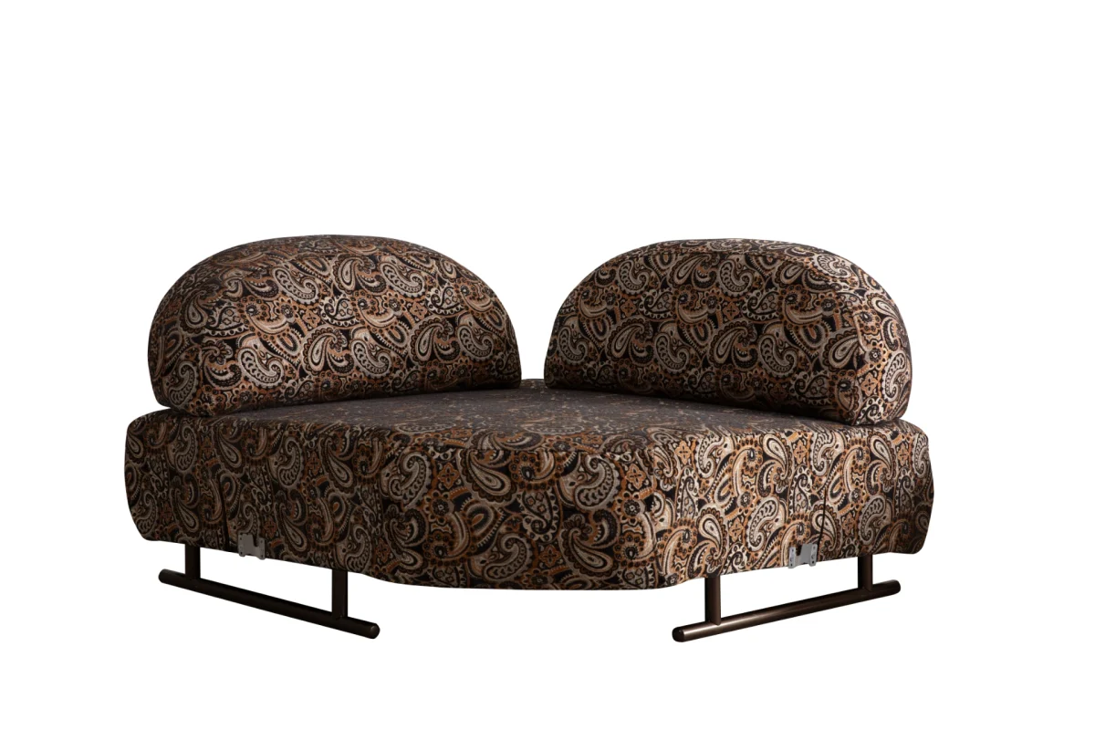 Tolia Corner Sofa - 4 Modules four-piece modular curved corner sofa in warm beige upholstery, featuring patterned accent pillows and a distinct corner module set against a modern wall.