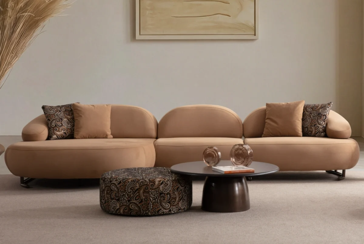Tolia Chaise Corner Sofa - 3 Module three-piece modular curved sofa featuring an extended chaise end, warm beige upholstery, and plush decorative cushions.