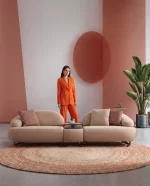 Tolia Sofa (with Mid. Wooden Module) modular beige sofa featuring organic curved seats and an integrated central wooden console table.