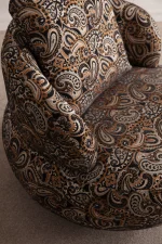 Tolia Armchair sculptured round swivel armchair featuring intricate paisley pattern upholstery and a plush back cushion.
