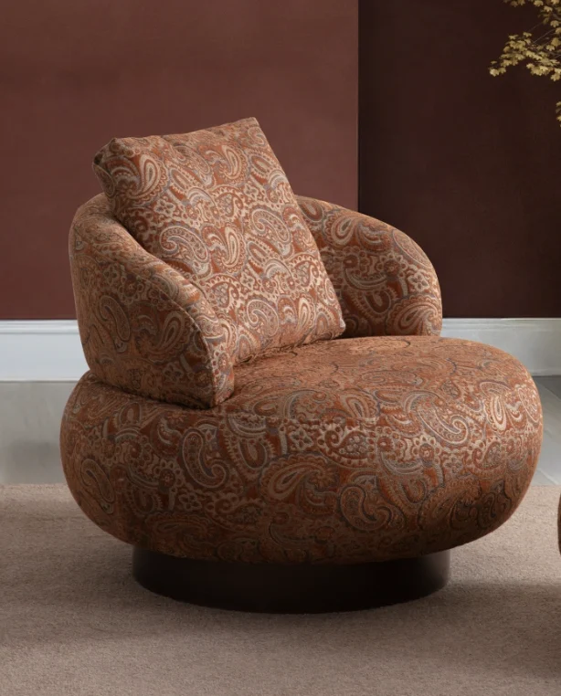 Tolia armchair stylish curved lounge armchair 6 Tolia Armchair sculptured round swivel armchair featuring intricate paisley pattern upholstery and a plush back cushion.